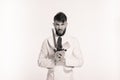 Studio shot of a happy bearded young chef holding sharp knives over white background. Chef with knife. Handsome angry serious chee Royalty Free Stock Photo