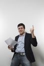 Studio shot of happy businessman celebrating a paper Royalty Free Stock Photo