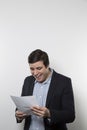 Studio shot of happy businessman celebrating a paper Royalty Free Stock Photo