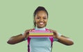 Happy black school or college student girl holding a stack of her notebooks and smiling Royalty Free Stock Photo