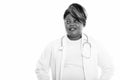 Studio shot of happy fat black African woman doctor smiling while thinking Royalty Free Stock Photo