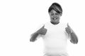 Studio shot of happy fat black African woman smiling while giving thumbs up ready for gym Royalty Free Stock Photo