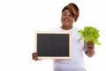 Studio shot of happy fat black African woman smiling and thinkin Royalty Free Stock Photo