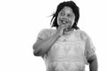 Studio shot of happy fat black African woman smiling while thinking and looking up Royalty Free Stock Photo