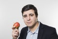 Studio shot of happy person eating an apple