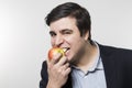 Studio shot of happy person eating an apple