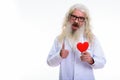 Studio shot of happy senior bearded man doctor smiling and givin Royalty Free Stock Photo