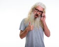 Studio shot of happy senior bearded man smiling while giving thu Royalty Free Stock Photo