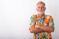 Studio shot of happy senior bearded tourist man smiling with arm Royalty Free Stock Photo