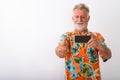 Studio shot of happy senior bearded tourist man smiling while gi Royalty Free Stock Photo