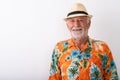 Studio shot of happy senior bearded tourist man smiling Royalty Free Stock Photo