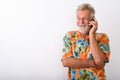 Studio shot of happy senior bearded tourist man smiling and thin Royalty Free Stock Photo