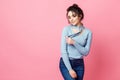 Studio shot of happy young fair-haired woman dressed casually jeans and blue blouse. pink background. copy space Royalty Free Stock Photo