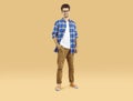 Portrait of a happy male student in glasses and casual clothes standing on a studio background Royalty Free Stock Photo