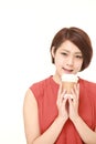 Studio shot of Japanese woman takes a coffee break Royalty Free Stock Photo