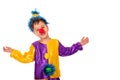 Studio portrait of a little boy wearing carnival costume of a clown with a red round nose, isolate. He spread his arms and smiles