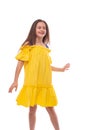 Studio shot of a little smiling active girl wearing yellow sundress , isolated Royalty Free Stock Photo