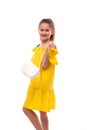 Studio shot of a little smiling girl with bag wearing yellow sundress , isolated Royalty Free Stock Photo