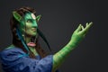 Mythical female elf with green skin and outstretched arm