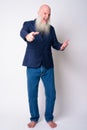 Full body shot of happy mature bearded bald businessman pointing at camera Royalty Free Stock Photo