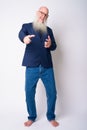 Full body shot of happy mature bearded bald businessman pointing at camera Royalty Free Stock Photo