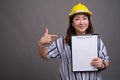 Mature Asian businesswoman construction worker wearing hardhat Royalty Free Stock Photo