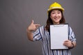 Mature Asian businesswoman construction worker wearing hardhat Royalty Free Stock Photo