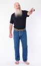 Full body shot of happy mature bald man with long gray beard pointing finger Royalty Free Stock Photo
