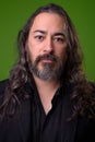 Studio shot of mature handsome bearded multi-ethnic businessman with long hair Royalty Free Stock Photo