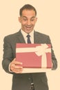 Mature happy Persian businessman opening gift box Royalty Free Stock Photo