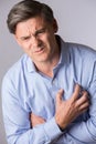 Studio Shot Of Mature Man Suffering Heart Attack Royalty Free Stock Photo