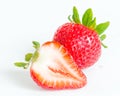 Studio shot one whole organic strawberry with a half cut isolated on white Royalty Free Stock Photo