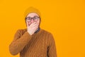 Studio shot on orange background of an isolated shocked scared surprised caucasian man looking at camera with his eyes Royalty Free Stock Photo