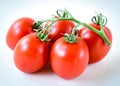 Studio shot organic five on vine ripened Roma tomatoes isolated on white background Royalty Free Stock Photo