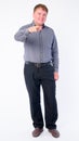 Full body shot of happy overweight businessman pointing at camera Royalty Free Stock Photo