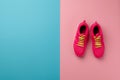 A studio shot of pair of running shoes on pink background. Flat lay.