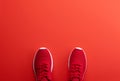 A studio shot of pair of running shoes on red background. Flat lay.