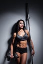 Studio shot of perfect body of bodybuilder female with barbell a Royalty Free Stock Photo