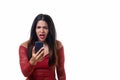 Angry woman yelling while looking at her phone Royalty Free Stock Photo