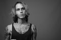 Studio shot of rebellious young man against gray background