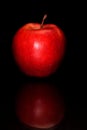 Studio shot of red apple with reflection isolated on a black background Royalty Free Stock Photo