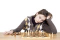 Studio Shot Of Sad Girl Leaning Her Head On Hand Trying To Concentrate On The Chess Game On White