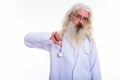 Studio shot of senior bearded man doctor giving thumb down Royalty Free Stock Photo
