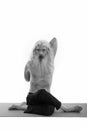 Studio shot of senior bearded man doing yoga poses with hands in the back shirtless Royalty Free Stock Photo