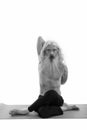 Studio shot of senior bearded man doing yoga poses with hands in the back shirtless Royalty Free Stock Photo