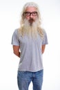 Studio shot of senior bearded man standing while wearing eyeglas