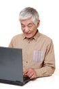 Senior Japanese  man using laptop computer Royalty Free Stock Photo