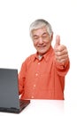 Senior Japanese  man using laptop computer Royalty Free Stock Photo