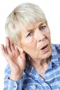 Studio Shot Of Senior Woman Suffering From Deafness