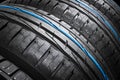 Studio shot of a set of summer car tires on black background. Tire stack background. Car tyre protector close up. Black rubber tir Royalty Free Stock Photo